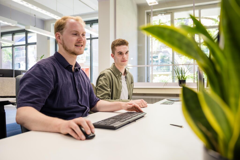 Brandon kijkt mee met collega Joost
